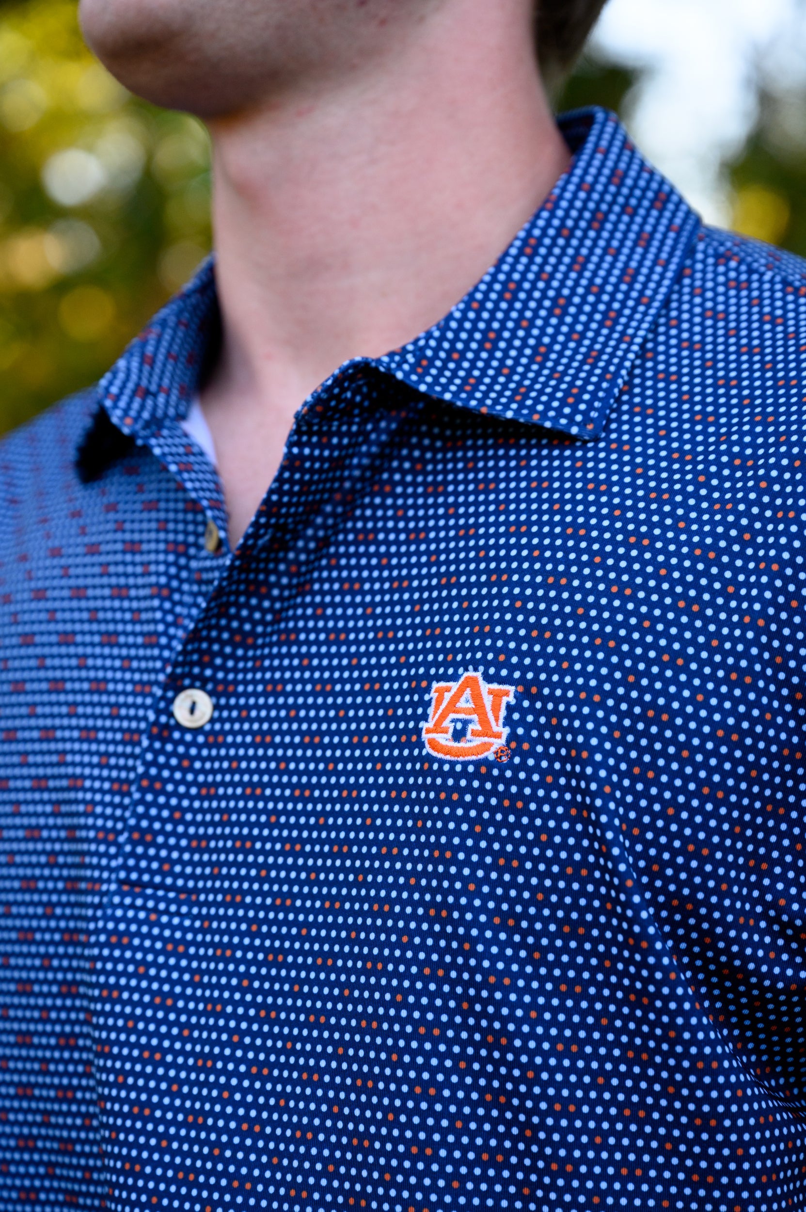 Auburn University AU Team Dot Polo (AU Logo) Navy Men's JNJ Performance Polo with a pattern of Light Blue and Orange Dots and AU Logo Embroidery