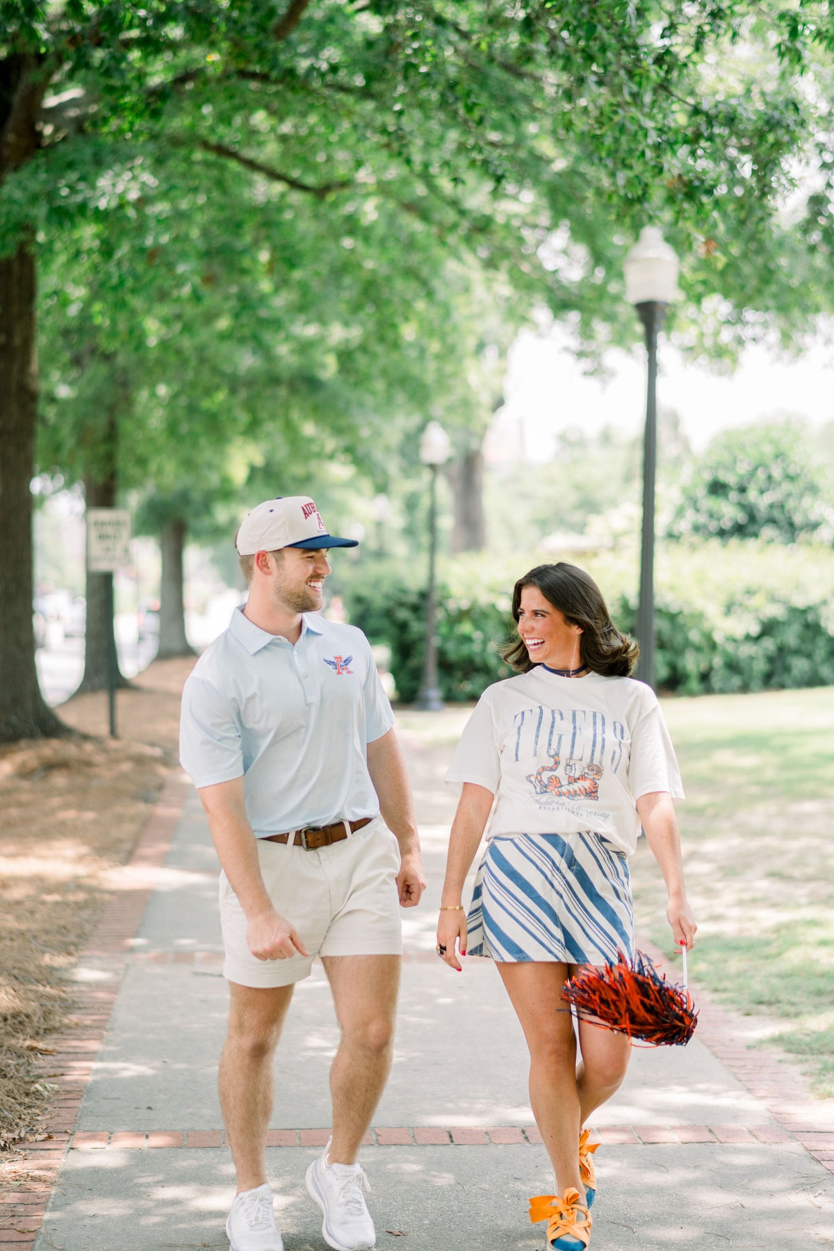Auburn University Ivory T-Shirt with navy text “Tigers” above Aubie laying down