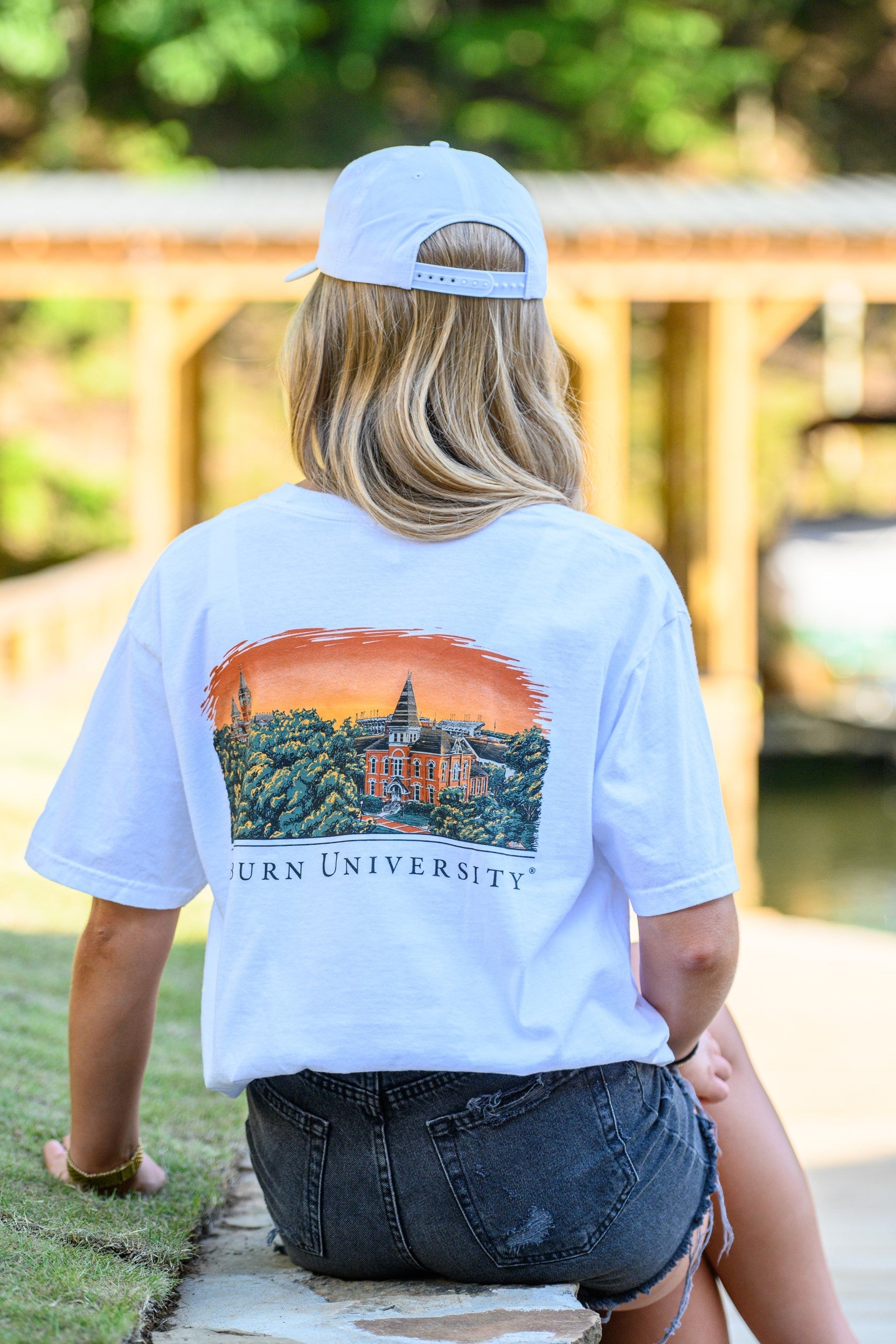 Auburn University Auburn Skyline White Comfort Colors T-Shirt with an image of a sun setting on the University above text "Auburn University"