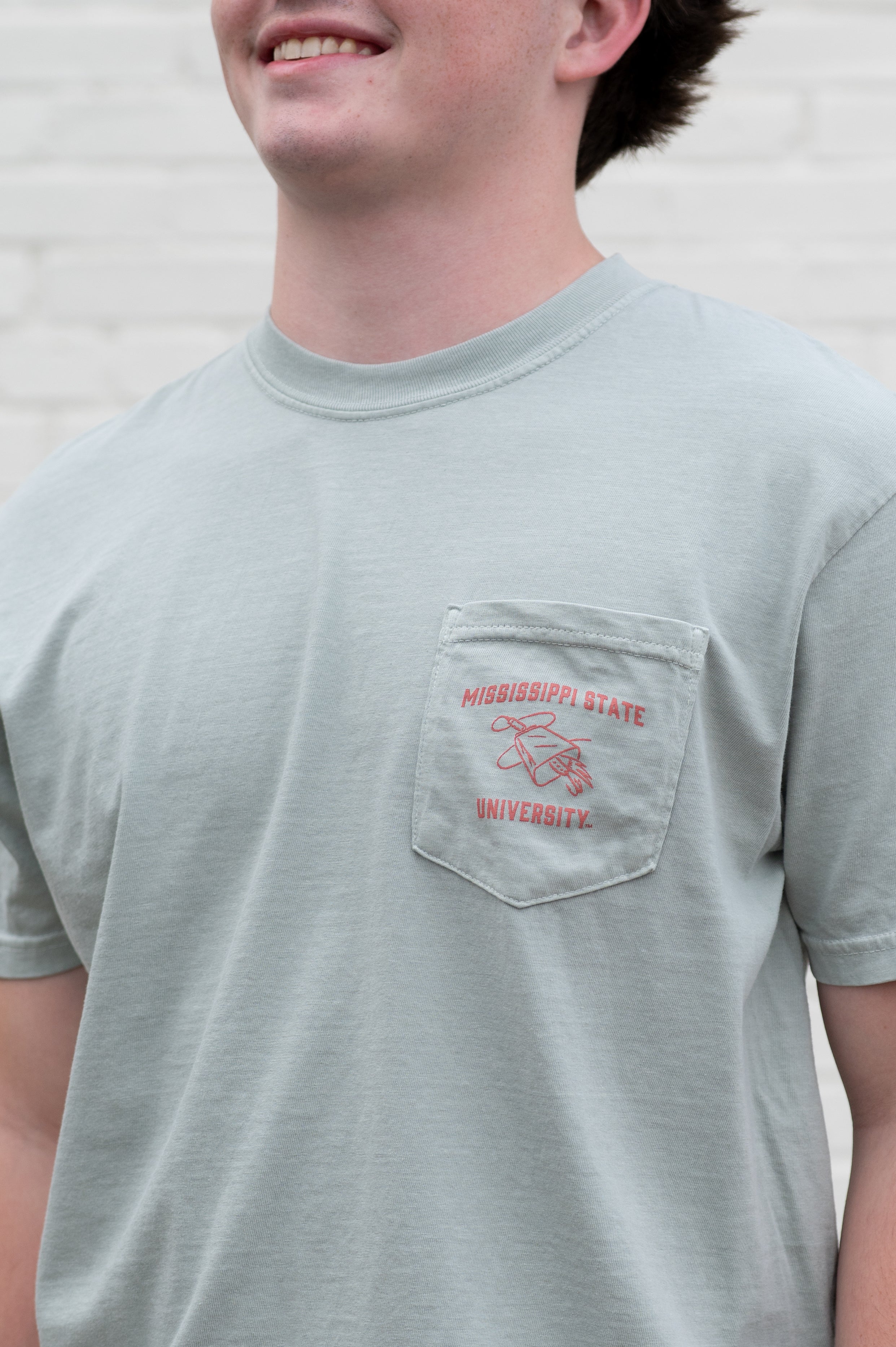 Mississippi State Light Green T-Shirt with an image of Bully bass fishing in a boat