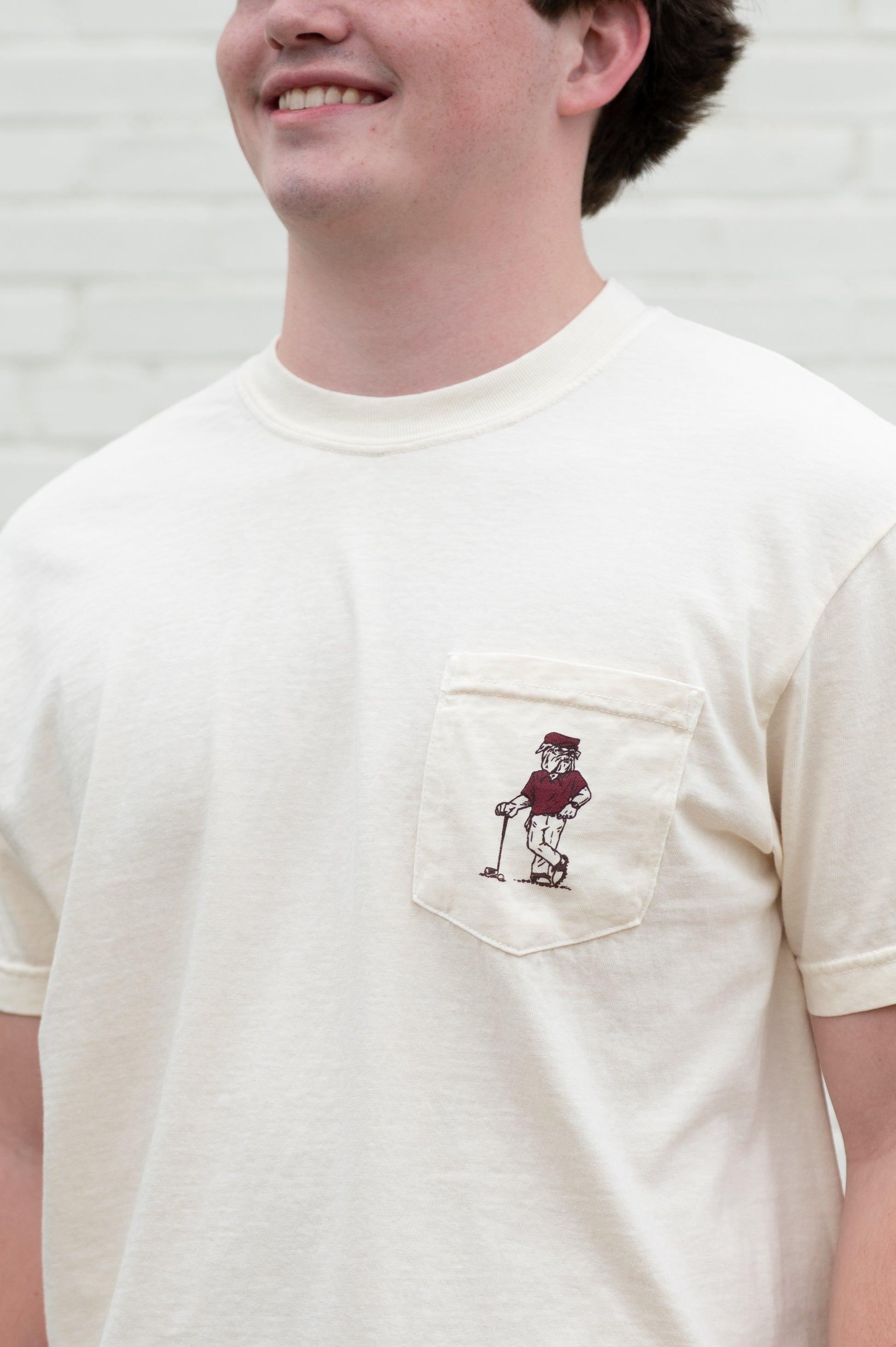 Mississippi State Ivory T-Shirt with an image of Bully leaning against a golf club between Maroon Text "Mississippi State" and "Ring True"