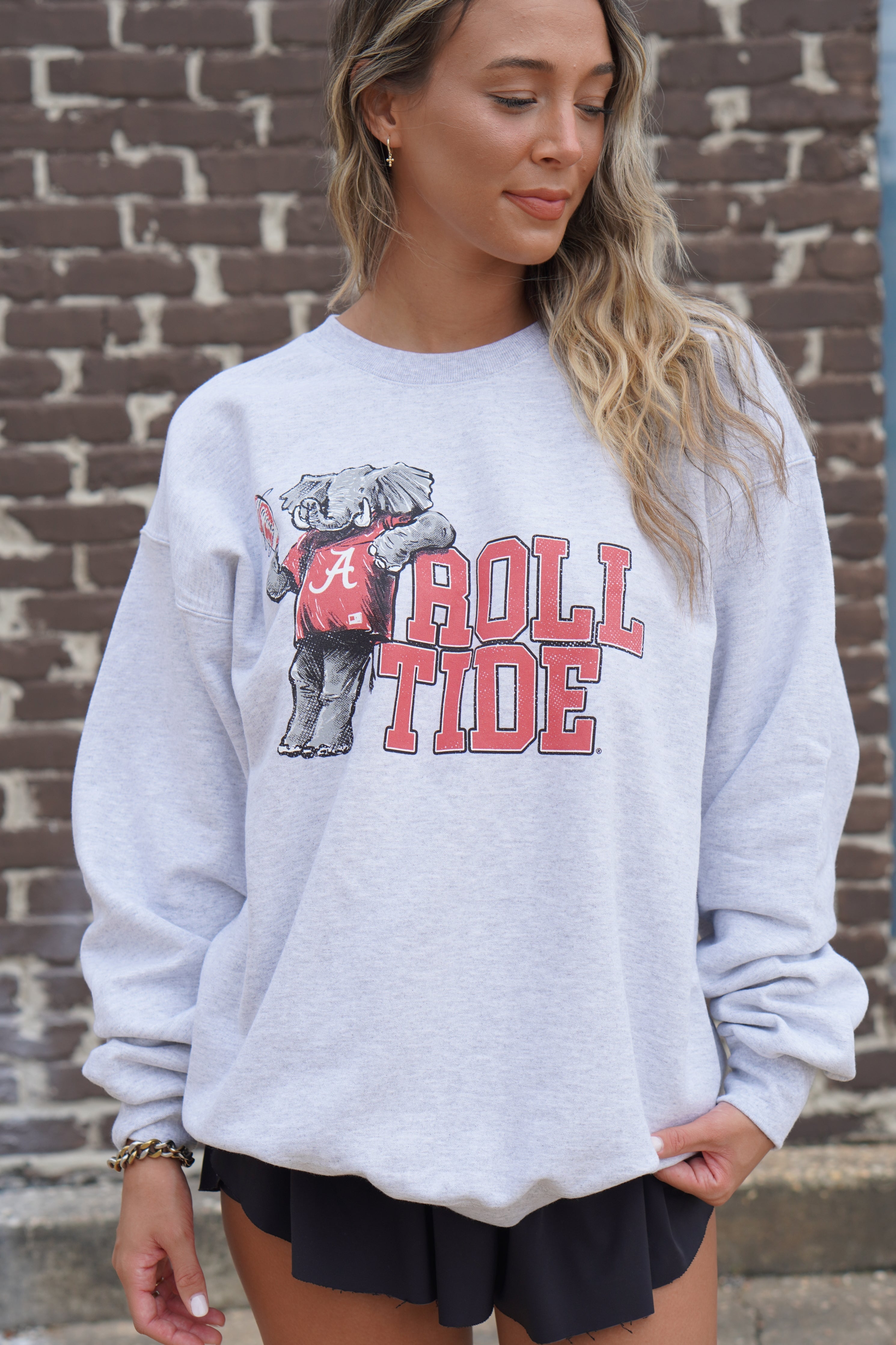 University of Alabama Gray Chill Big Al Sweatshirt with Red text "Roll Tide" and a graphic of Big Al leaning against the "R" of "Roll"