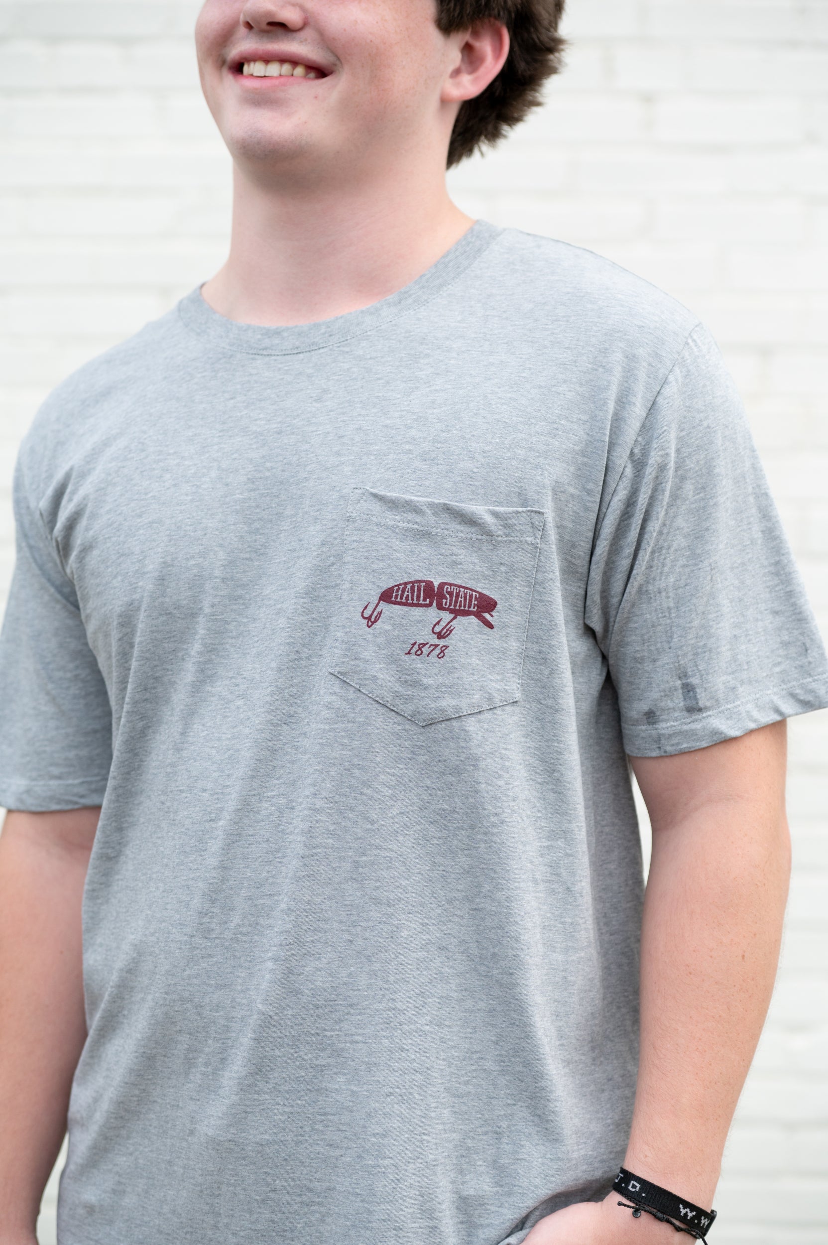 Mississippi State Grey T-Shirt with an image of a fishing lure with Red text “Hail State”