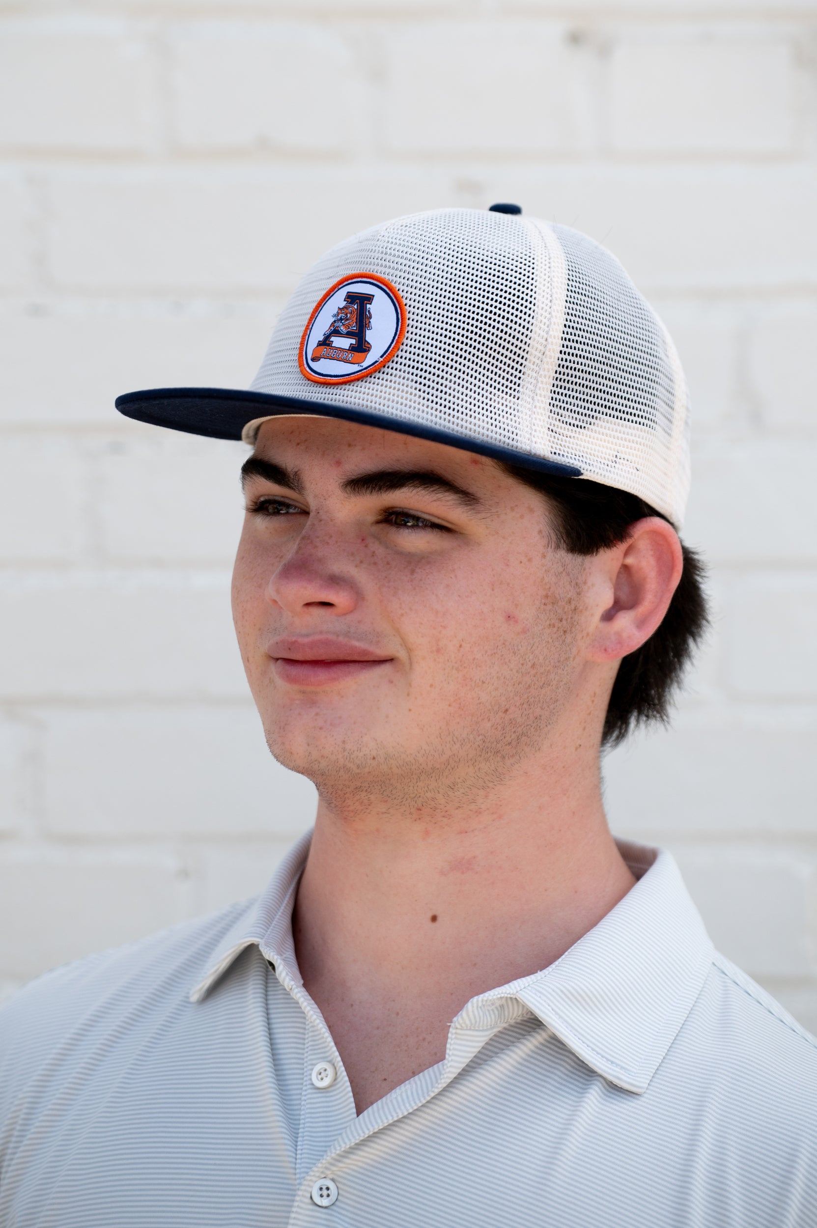 Auburn University White and Navy Hat with embroidery of Aubie leaping through an "A"