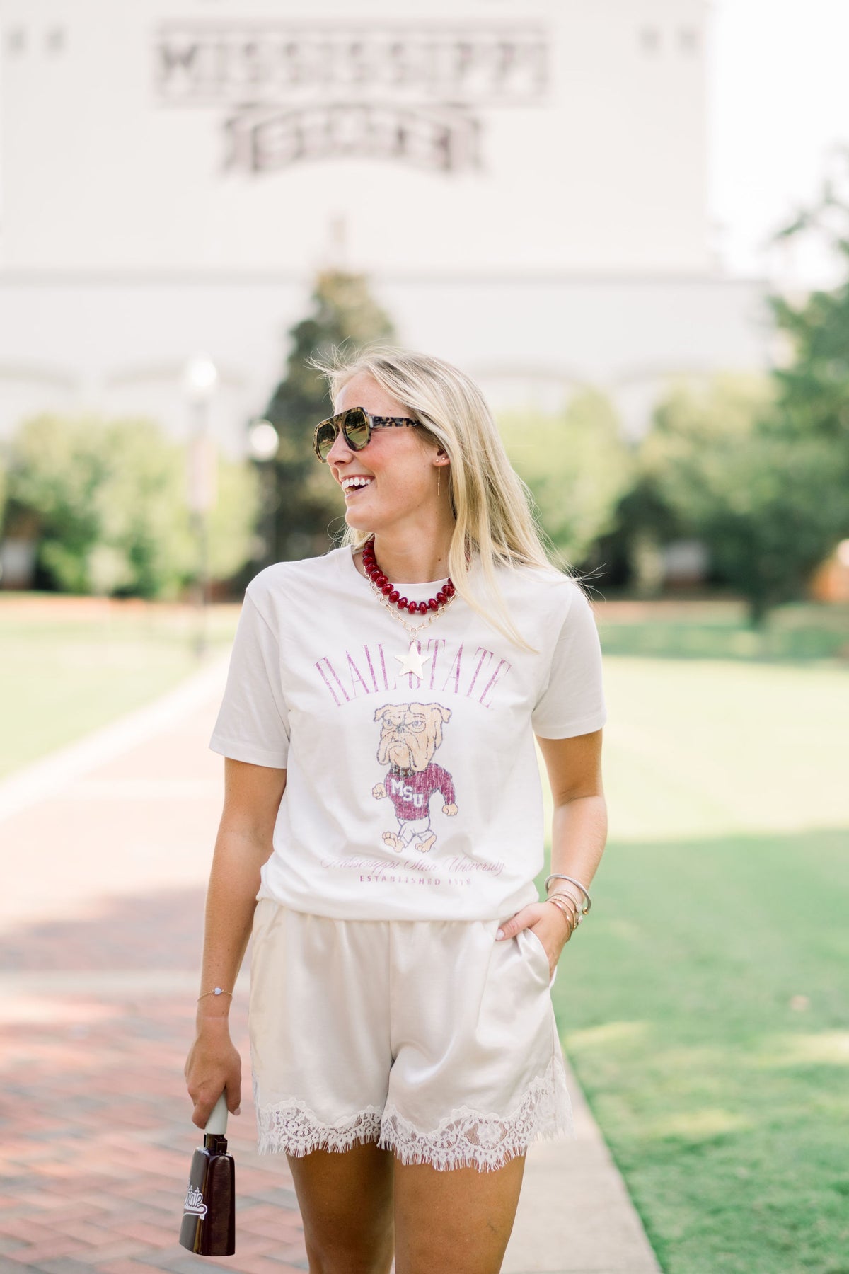 Mississippi State Ivory T-Shirt with Red text “Hail State” above an image of the Walking Bully Logo