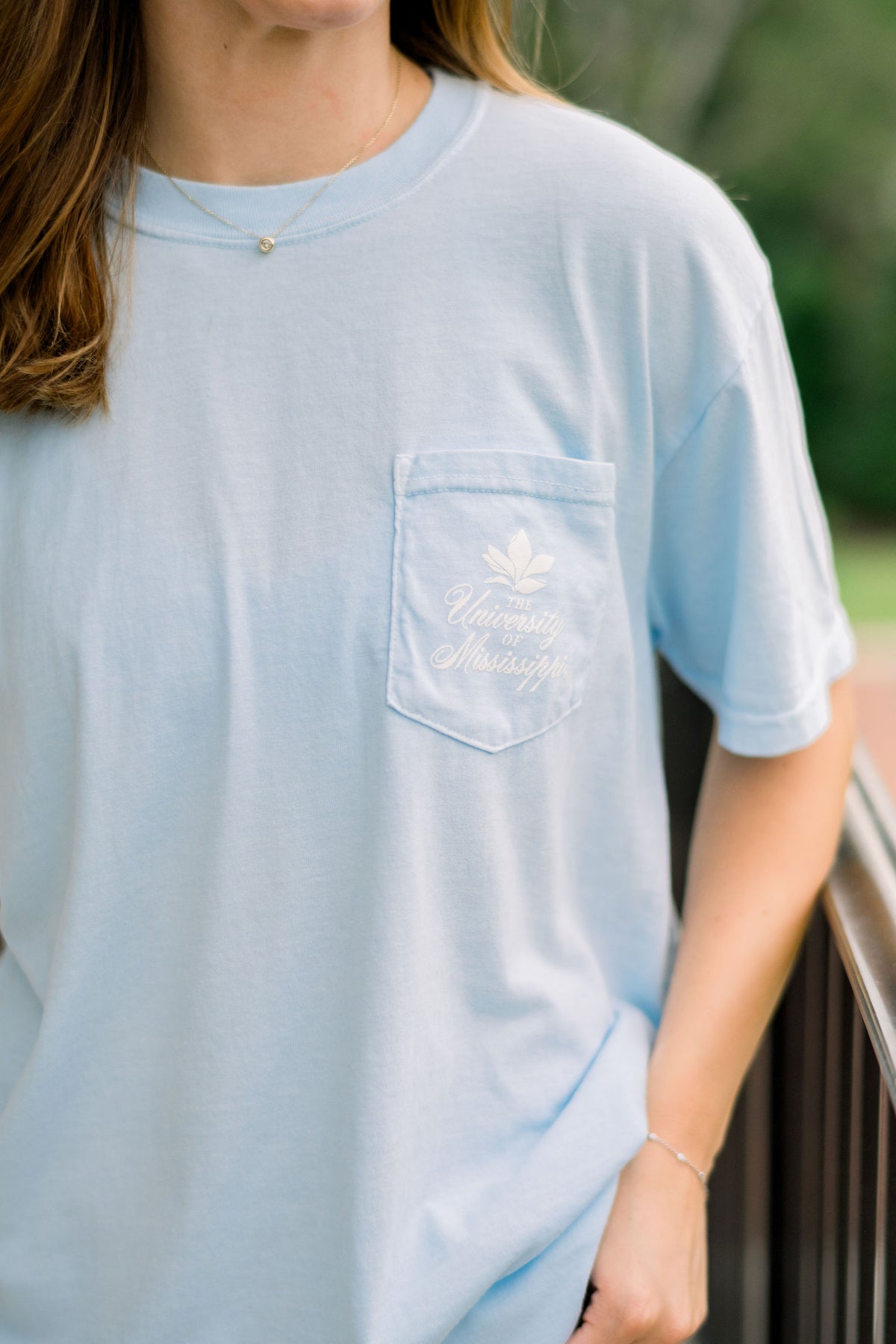 Ole Miss Light Blue Front Pocket with a White Magnolia Graphic above White text, “The University of Mississippi”