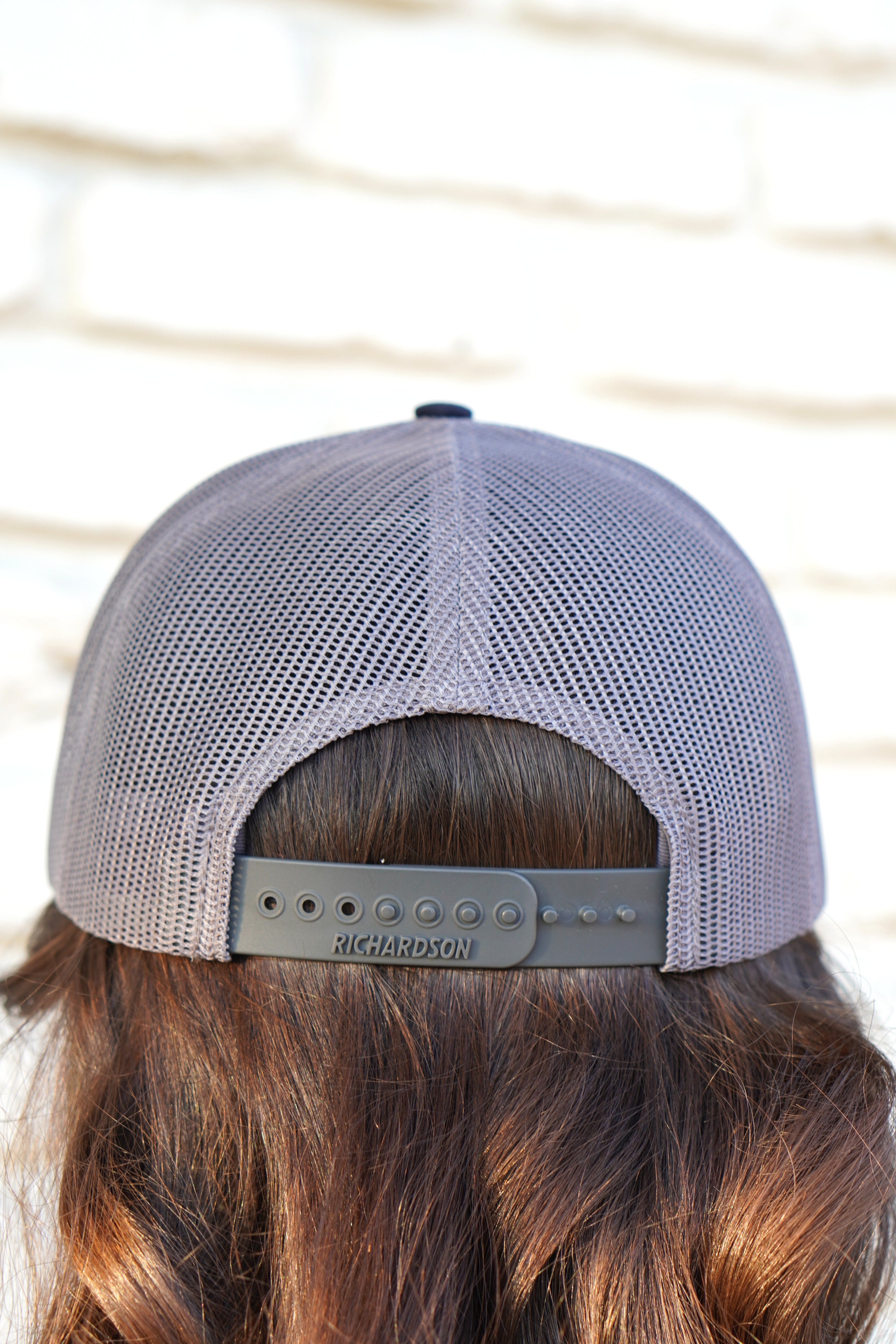 Auburn University Grey and Navy Trucker Hat with the Original Aubie basketball logo on the front, featuring a gray crown and black visor.