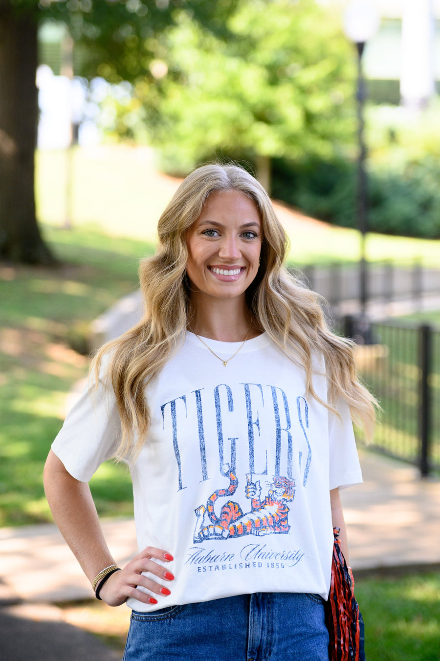 Auburn University Ivory T-Shirt with navy text “Tigers” above Aubie laying down