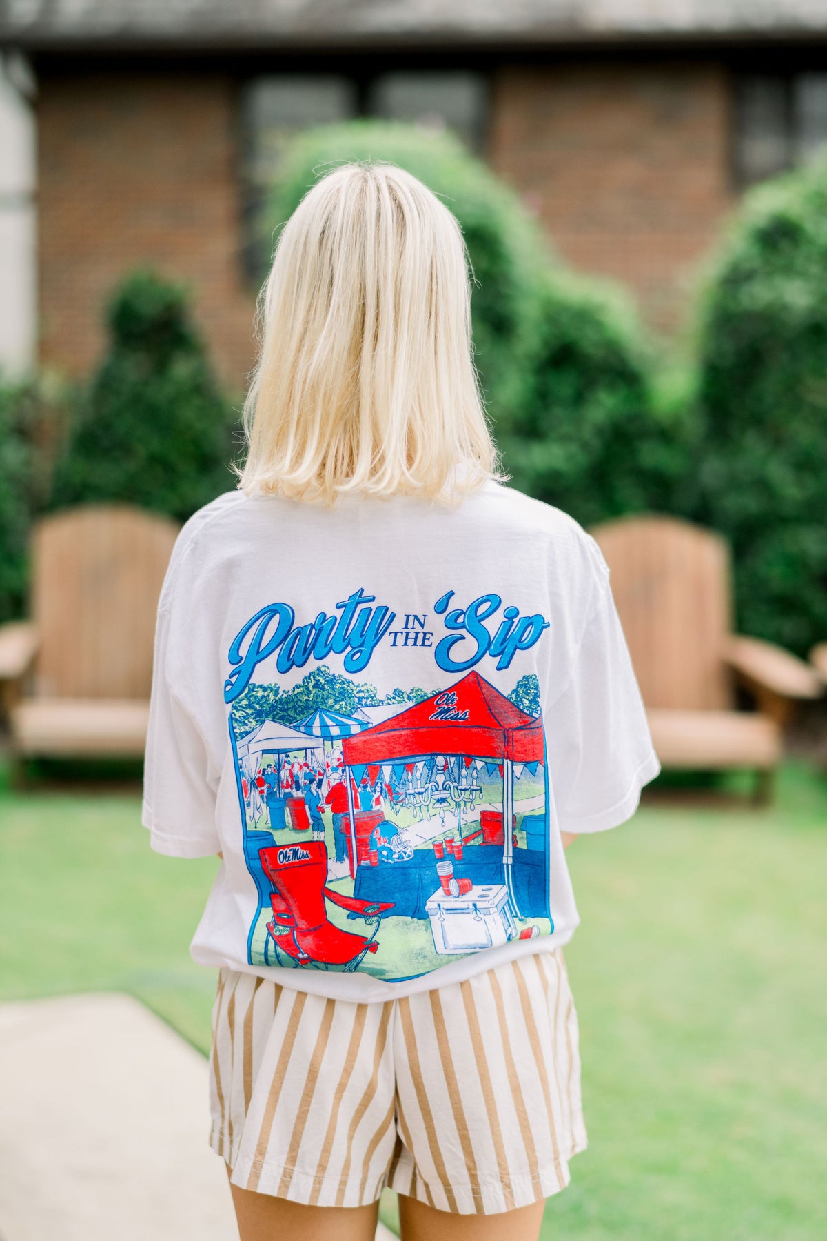 Ole Miss White Shirt with an image of tailgate tents on the Grove under text “Party in the ‘Sip”