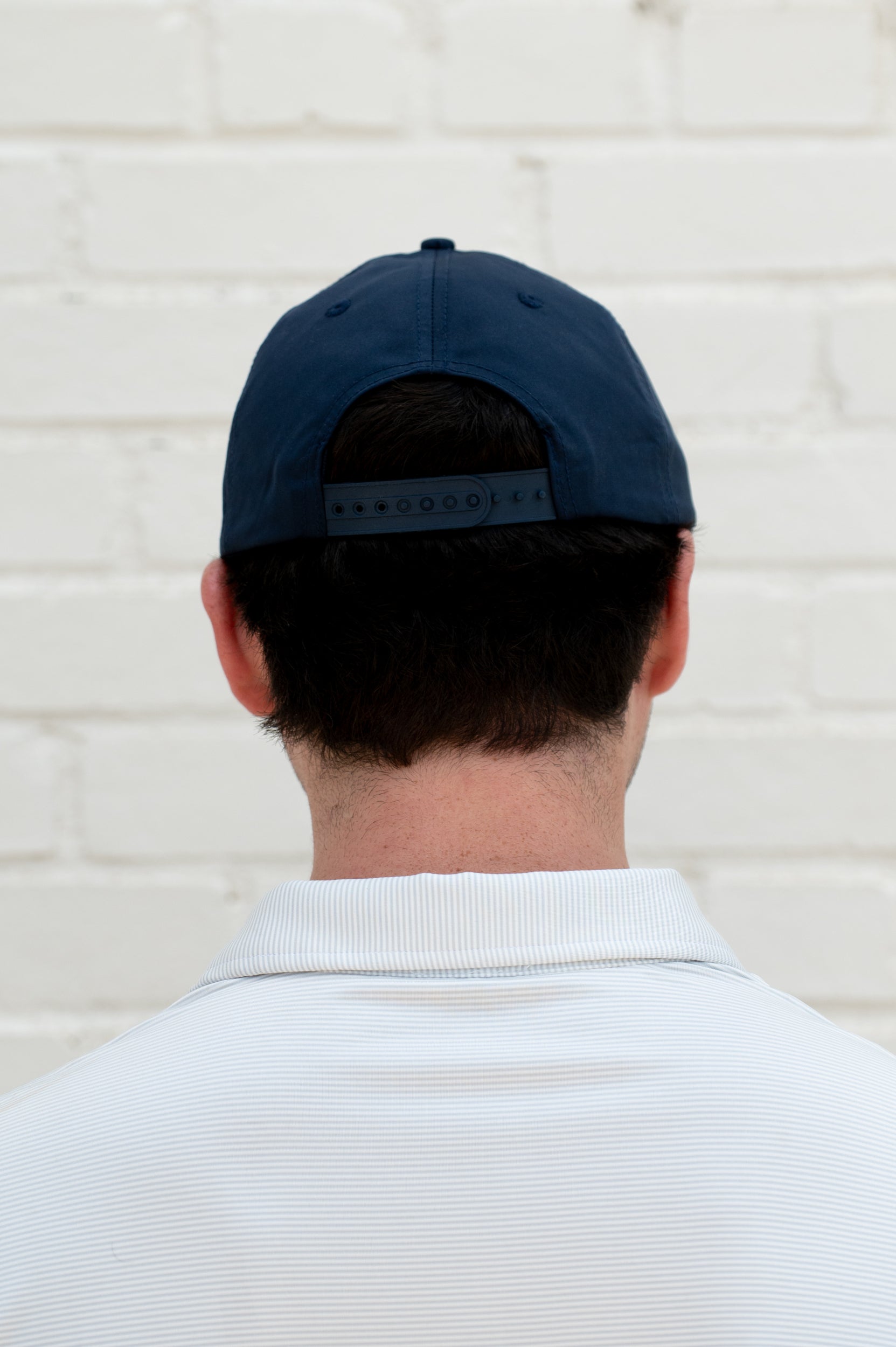 University of Alabama Navy Hat with a White Rope and White text “Tide” above an image of a golf hole